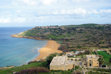 on red sandy beach in Ramla Bay, Gozo, Malta
