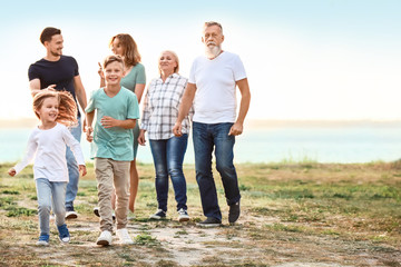 Big family resting together in park
