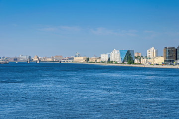 Fototapeta premium Malookhtinskaya Embankment with Bolsheokhtinsky Bridge and modern buildings of Leorsa Group in Saint Petersburg, Russia