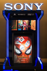 Obraz premium Bangkok, Thailand - Jun 24, 2019: Spider-Man: Far From Home poster and TV screen kiosk display showing movie trailer in theatre. Cinema promotional advertisement, or film industry marketing concept