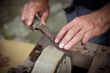 Sharpening knife on old grindstone wheel