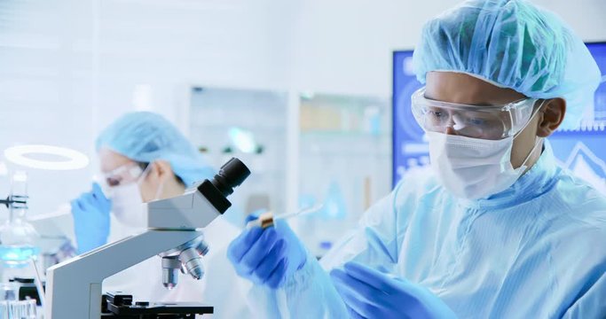 asian scientist take petri dish