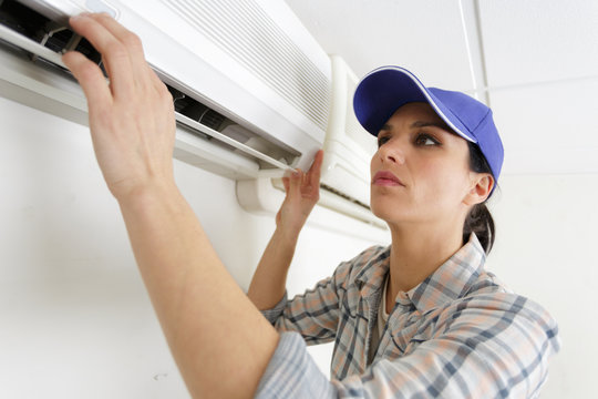 female operator inspecting air conditioning