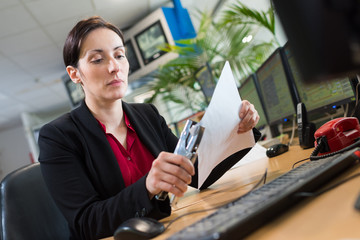 woman stapling papers with stapler