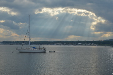 Fototapeta premium boat in the bay with streams of light