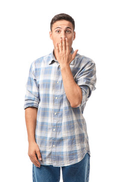 Portrait of shocked young man on white background