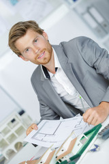 man architect draws a plan