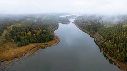 Aerial shot of a peaceful lake  or river on a misty autumn morning