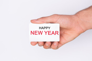 Happy new year . Hand holding a white card . White background. Copy space