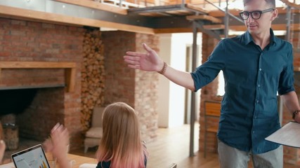 Business Man is Riding Self-Balancing Hoverboard Scooter, Coming to Startup Loft Office and Greeting Coworkers by High Five. 4K Gimbal Corporate Leading Toe to Head Shot