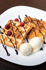 Viennese waffles with ice cream, chocolate and cherry.