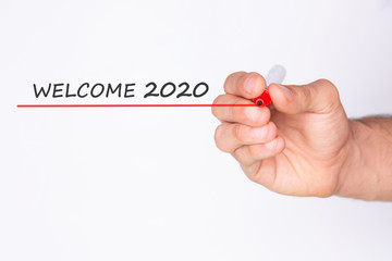 Welcome 2020. Hand holding a white card . White background. Copy space