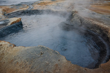 Boiling mudpots in the geothermal area Hverir and cracked ground around, Iceland in summer. Myvatn region, North part of Iceland