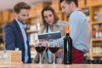 glasses of red wine and bottle in a wine cellar