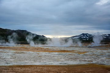 Boiling mudpots in the geothermal area Hverir and cracked ground around, Iceland in summer. Myvatn region, North part of Iceland