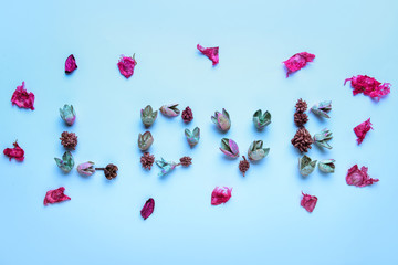 Word LOVE made of floral decor on color background