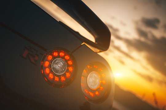 SISTIANA, ITALY JUNE 12, 2013: Photo of a Nissan GT-R Black Edition backlights at the sunset. The Nissan GT-R is a 2-door 2+2 sports car produced by Nissan and unveiled in 2007.