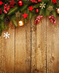 Christmas wooden background with decoration and fir tree. View with copy space.