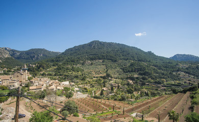 Fototapeta na wymiar A Beautiful greenish mountains view from a nice viewpoint at the village of Valldemossa in Palma de Mallorca Spain. 