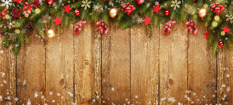 Christmas wooden banner with decoration and fir tree. Snow and light. View with copy space.