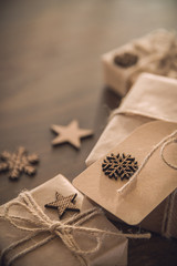 Christmas season. Gift boxes with wooden decor on the rustic table