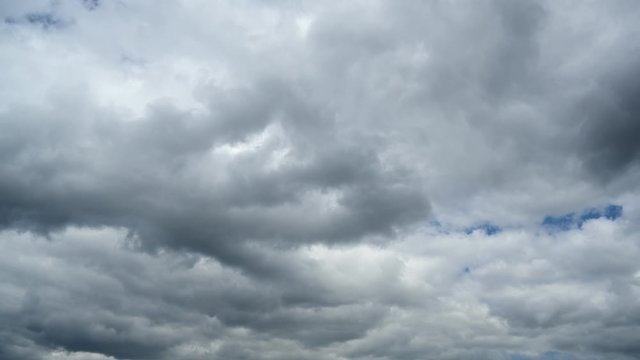 Time lapse of dark clouds running through the blue sky