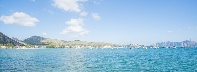 A beautiful water view and a boat docking in a dock at Puerto De Pollensa beach in Palma De Mallorca , Spain.