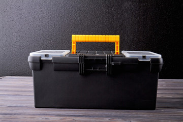 Close up tool box on dark background. Black case with tools and instruments. Repair tool kit.