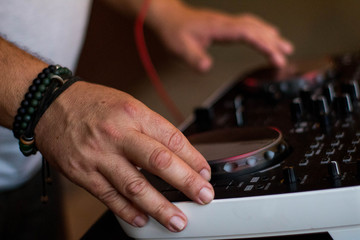 Brazilian Music Festival,  DJ hands hold microphone and mixing DJ remote