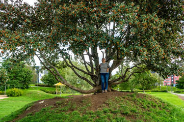 Mature woman in striped shirt walks in Park