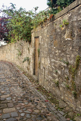 Fototapeta na wymiar Cobbled Street and Stone Wall in Culross, Scotland