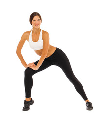 Fototapeta premium Sexy fitness woman posing in studio - isolated on a white background