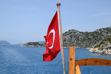 Turkey flag at the stern of a pleasure yacht. View of Mediterranean coast