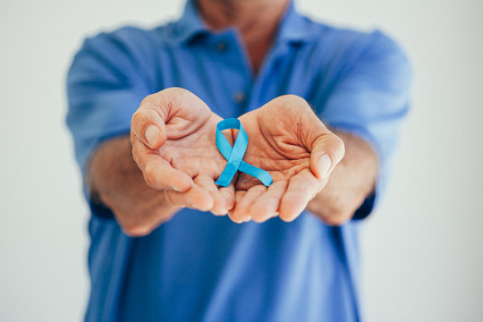 Prostate Cancer Awareness. Man with light Blue Ribbon for supporting people living and illness. Men Healthcare and World cancer day concept