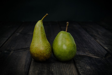 Pear on a dark wooden table. The concept of eating fruit, eating meals with vitamins. Taking care of yourself, diet. Healthy food, apples, pears.