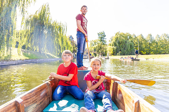 Father with children on family punting in Cambridge
