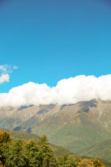 Fototapeta premium autumn sky with clouds, landscape of mountains and waterfall