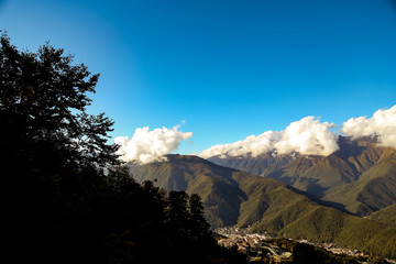 autumn sky with clouds, landscape of mountains and waterfall