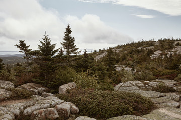 Hiking along granite bedrock on the summit of Cadillac Mountain in Acadia National Park on Mount Desert Island, Maine.