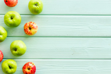 Autumn composition with fresh apples on green wooden background top view pattern copy space