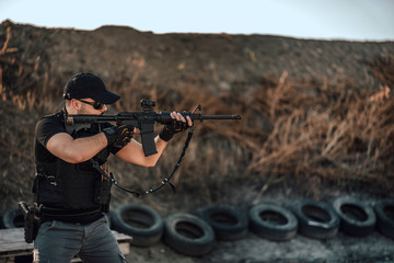 Special force member shooting with sniper rifle.
