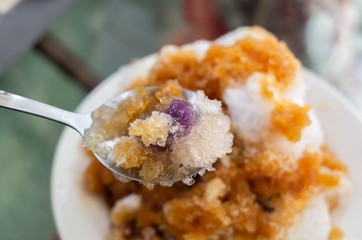 eating shaved ice with colorful dessert