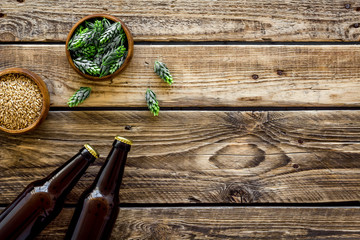 Barley and hop for making beer on rustic wooden background top view copy space