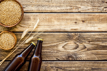 Beer background with barley on rustic wooden background top view copy space