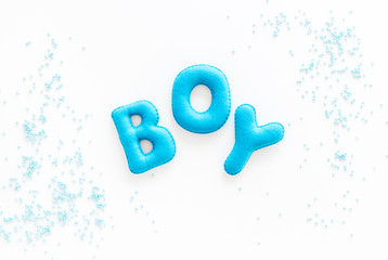 Boy word as decoration for baby shower on white background top view copy space