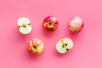 Red apples pattern on pink background top view