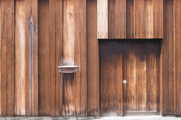 An entrance of a wooden modern house