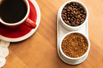 Beans, ground coffee and coffee in a cup