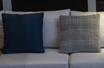 Modern blue fabric pillows and checkered pattern on the cushion gray sofa interior decoration