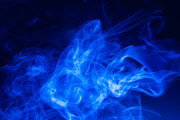 Fototapeta premium Blue smoke on black background.